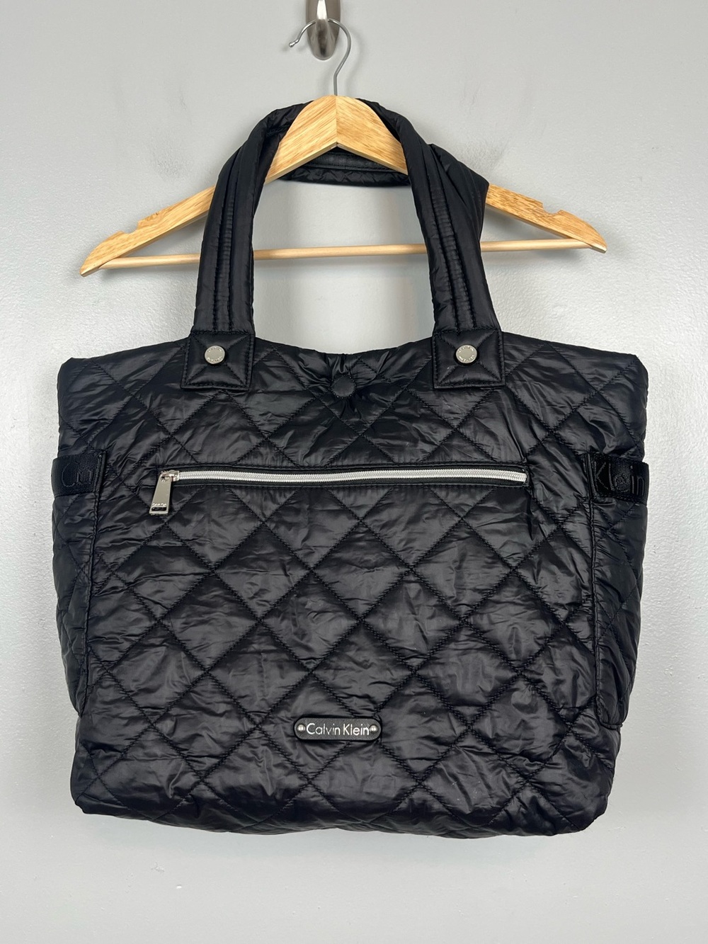 Calvin Klein black puffer magnetic closure tote bag.